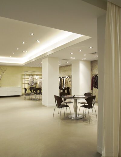 Modern boutique interior with soft lighting, minimalistic decor, and an intimate seating area.