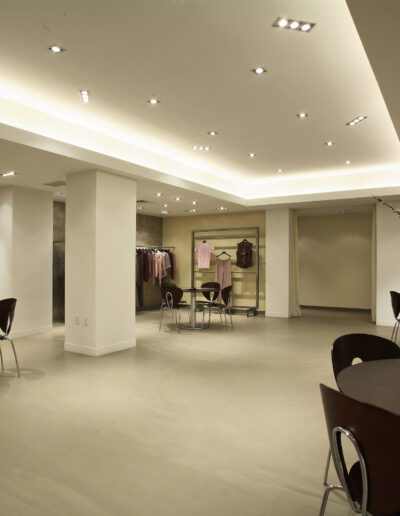 Elegant clothing boutique interior with modern lighting and seating area.